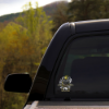 Close-up of the gnome sticker on the back window of a car.