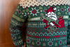 Image of a red and green Christmas sweater featuring an FN gnome